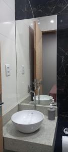 a bathroom with a white sink and a mirror at La Bella Luna Suítes in Alto Paraíso de Goiás +16 photos