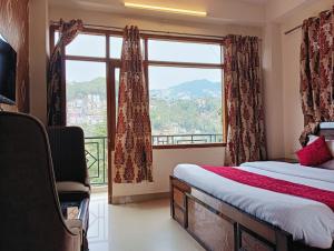 a bedroom with a bed and a large window at ASTON HOME STAY in Chhota Simla