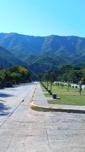 an empty street with mountains in the background at Departamento para 2 personas in Bialet Massé
