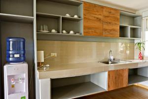 a kitchen with a sink and a refrigerator at Tanawin BnB in Orani