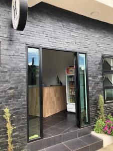 a restaurant with large glass doors on a brick wall at HOTEL LA BONGA in Puerto Limón