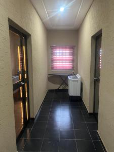 an empty hallway with a window and a radiator at LGH (Luxury Guest House) Résidence in Lomé