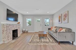 a living room with a couch and a fireplace at San Diego Heights - Urban Legend in San Diego