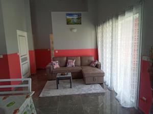 a living room with a couch and a table at Villa LANDREVA in Anse-Bertrand