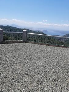 a view of the ocean from a hill with a fence at Sang Yoo Mountain View Tagaytay Bed and Breakfast - Taal Lake View in Tagaytay