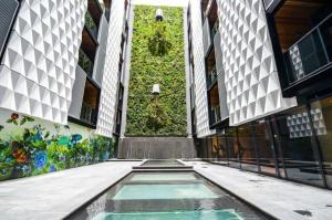 a building with a pool in the middle of a street at A Chic & Comfy 2BR Apt Near Federation Square in Melbourne