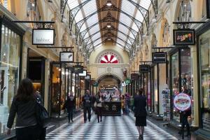 people walking through a shopping mall with a glass ceiling at A Chic & Comfy 2BR Apt Near Federation Square in Melbourne
