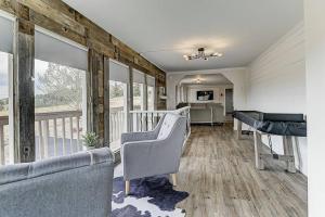 a living room with two couches and a balcony at Stay in a Historic Gold Mine Town w/Mountain Views in Victor