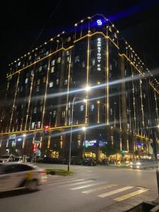 a large building with lights on top of it at night at Резиденс in Bishkek +8 photos