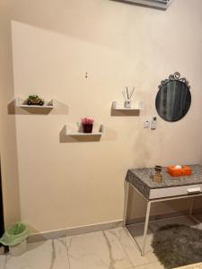 a room with a table and shelves on the wall at شقة روز تايم in Al Ain
