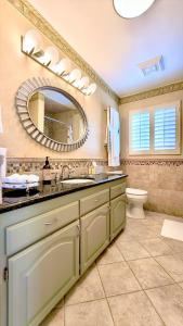 a bathroom with a sink and a mirror and a toilet at CASA LUX MONICA PRIME SANTA MONICA LUXURY HOME ONE-OF-A-KIND in Los Angeles