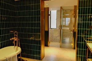a bathroom with a bath tub and a shower at Xinyu Hotel - Shanghai Jiao Tong University Xinhua Road in Shanghai