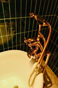 a bath tub with a metalaucet in a bathroom at Xinyu Hotel - Shanghai Jiao Tong University Xinhua Road in Shanghai
