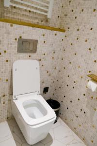 a bathroom with a toilet in a tiled wall at Xinyu Hotel - Shanghai Jiao Tong University Xinhua Road in Shanghai
