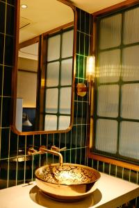 a bathroom with a sink and a mirror at Xinyu Hotel - Shanghai Jiao Tong University Xinhua Road in Shanghai