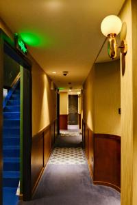 an empty hallway with stairs and green lights at Xinyu Hotel - Shanghai Jiao Tong University Xinhua Road in Shanghai