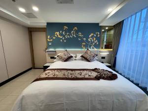 Ein Bett oder Betten in einem Zimmer der Unterkunft Yixuan Yasi Apartment-free shuttle during the Canton Fari