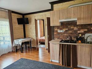 a kitchen with a counter and a table in a room at Симфонія біля річки Чан in Skole