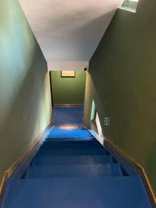 an empty hallway with blue stairs in a building at Xinyu Hotel - Shanghai Jiao Tong University Xinhua Road in Shanghai