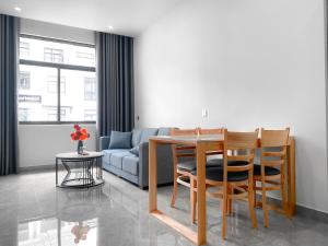 ein Wohnzimmer mit einem Tisch, Stühlen und einem Sofa in der Unterkunft Metahome Apartment HOT Độc Đáo Nhất Vinhome Marina in Haiphong