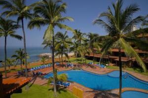 a view of the pool at a resort with palm trees at Los Tules Standard Hotel Room 903 - 3rd floor in Puerto Vallarta