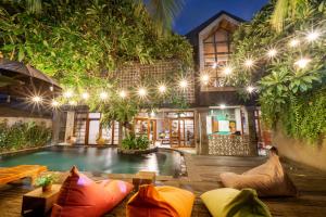 a resort with a pool in front of a building at Interconnection Hostel in Kuta