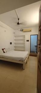 a bedroom with a bed in a room at cg residency in Pondicherry