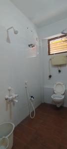 a bathroom with a toilet and a sink at cg residency in Pondicherry