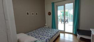 a bedroom with a bed and a sliding glass door at Ti Bamboo in Le Tampon