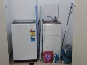 a kitchen with a sink and a refrigerator at Merrylands Hidden Gem! one Bedroom Apartment in Merrylands