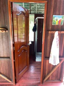 an open door of a wooden house with a door at Jungle Lodge with lookout tower in Pucallpa