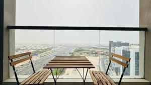 a table and two chairs in front of a large window at Upscale Studio Apartment Burj View with Balcony Free Parking by Belvilla in Dubai