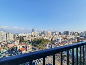 a view of a city from a balcony at Jeju Centerpoint N Residence in Jeju