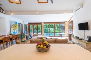 a living room with a bowl of fruit on a table at Enclose living 5Br Villa Center of Seminyak Near Beach in Seminyak