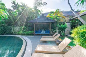 a backyard with a gazebo and a swimming pool at Enclose living 5Br Villa Center of Seminyak Near Beach in Seminyak