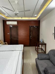 Pokój z łóżkiem, kanapą i stołem w obiekcie Temple View Home Stay w mieście Tiruvannamalai