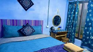 a blue bedroom with a bed and a table at My's Homestay sapa in Sapa