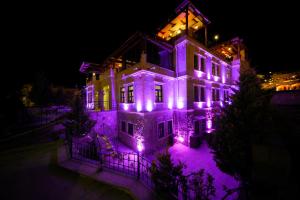 a house with purple lights on it at night at Alaturca House in Goreme