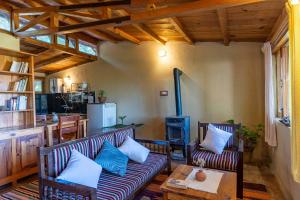 a living room with a couch and a table at Snow View Cottage Kasardevi in Almora