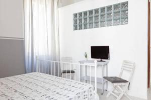 Un dormitorio con una cama y un escritorio con una computadora. en Domus Merulana Bed and Breakfast, en Roma