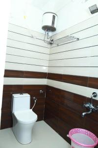 a bathroom with a toilet and a sink at CHANDRODAYAM RESIDENCY in Karaikal
