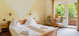 Postel nebo postele na pokoji v ubytování GRÜNER HEINRICH - Bett&Frühstück
