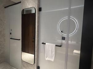a bathroom with a mirror and a towel at UrCove by HYATT Futian CBD in Shenzhen