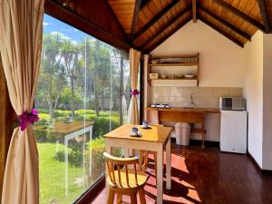 a kitchen with a table and a large window at Mckay's Quinta in Yaruguí