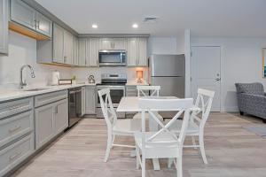 a kitchen with a white table and white chairs at Harbourtown Suites, Unit 213 in Plymouth