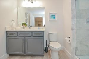 a bathroom with a sink and a toilet and a shower at Harbourtown Suites, Unit 213 in Plymouth