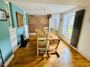 a kitchen and dining room with a table and chairs at Bi-Folds/Sonos/Large Open Plan/Central/Parking in Cheddar +41 photos