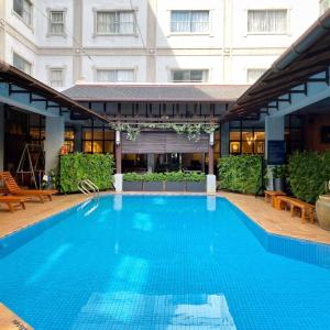 a large blue swimming pool in front of a building at Hotel Maluri in Kuala Lumpur