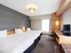 Cama ou camas em um quarto em Hotel Resol Trinity Hakata