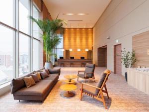 a living room with a couch and a table at Hotel Resol Trinity Hakata in Fukuoka